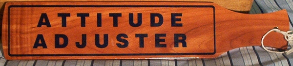 novelty paddle with the attitude adjuster written on it