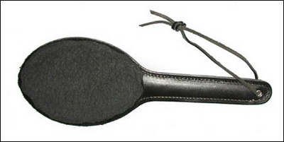 oval leather paddle with fur covering on one side