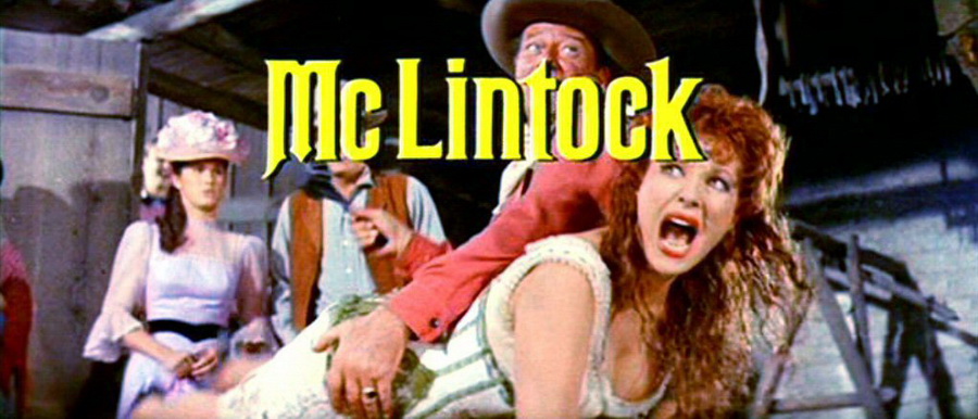still from the famous spanking scene in the movie mclintock