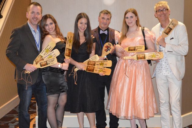 people holding paddles at teh lone star spanking party