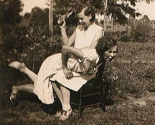vintage photo of one girl spanking another
