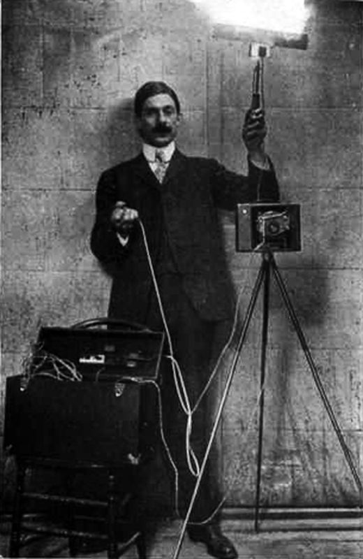 photographer with early flash camera