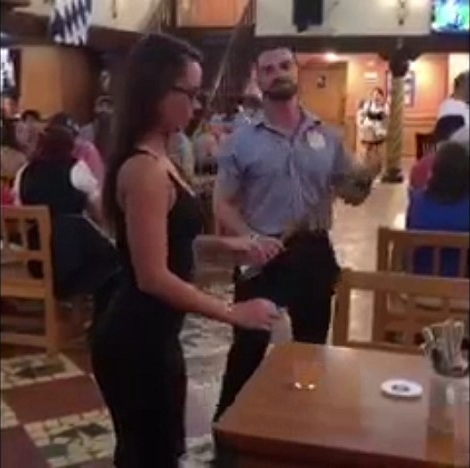 another young woman drinks the shot and takes the swat at the hofbrauhaus
