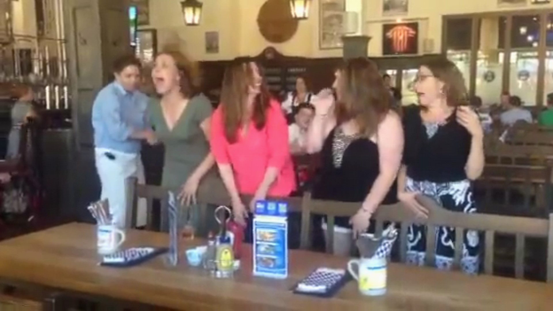 four women line up to be paddled at the hofbrauhaus restaurant in las vegas