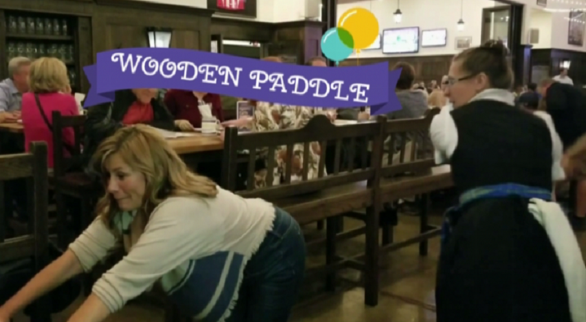 two more women getting paddled at the hofbrauhaus
